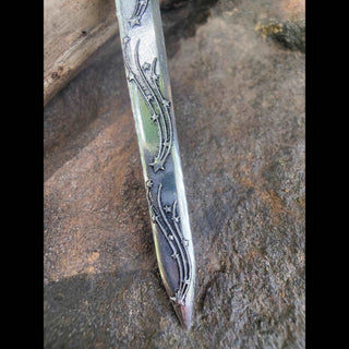 A close-up of the dagger's lower portion, highlighting the engraved star and celestial motifs running down the blade. The fine details evoke the enchanting beauty of a starlit sky.